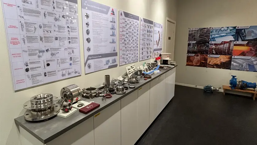 A display room with informative posters and a collection of AES seals on a sideboard.
